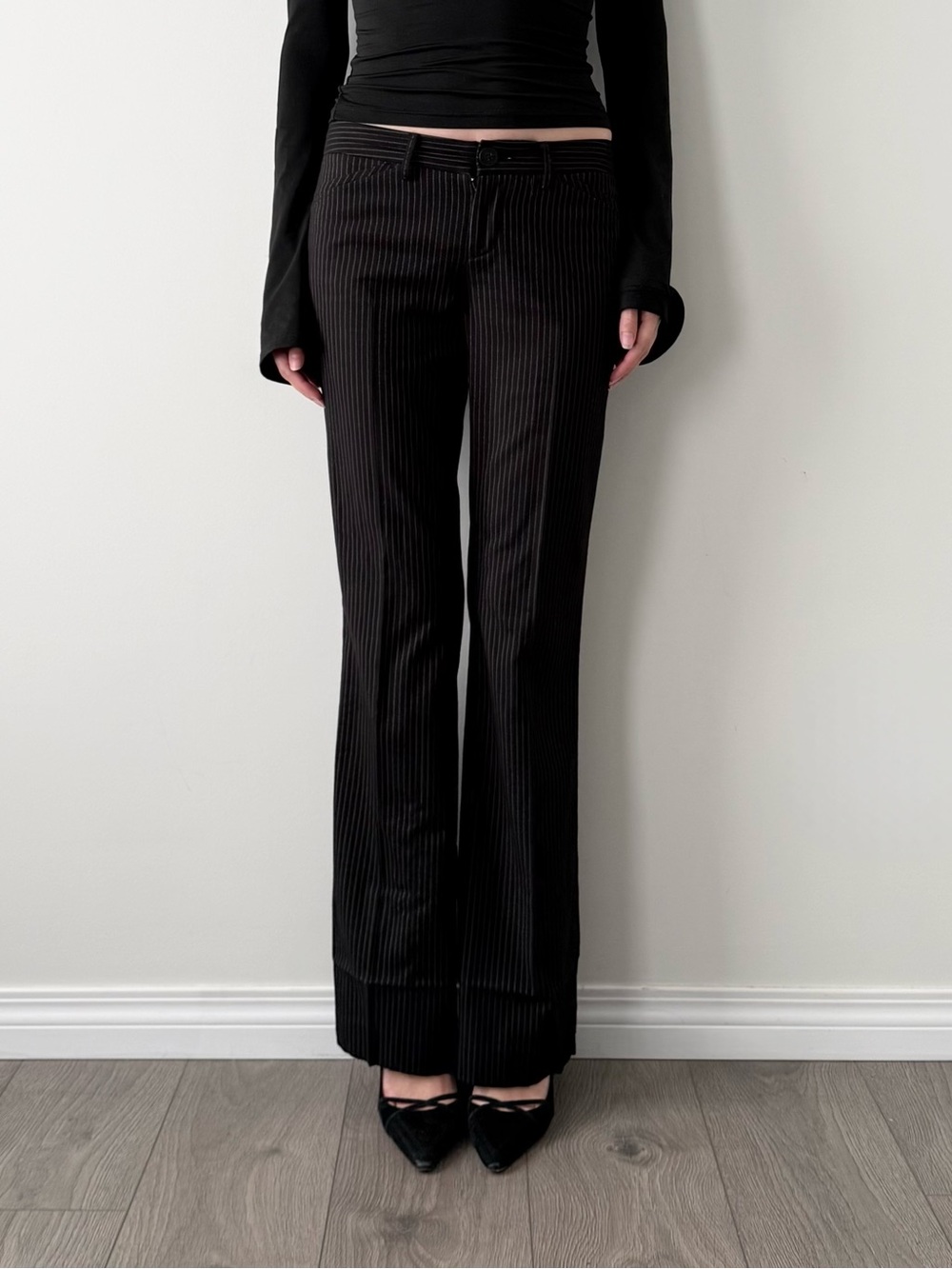 Talulah black pinstripe low rise flared trousers.